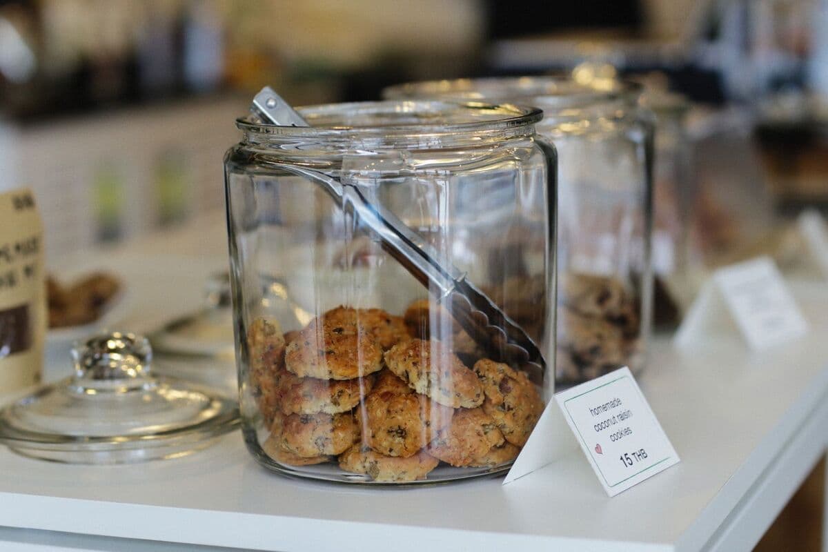 glass jars filled with cookies displayed on a white table